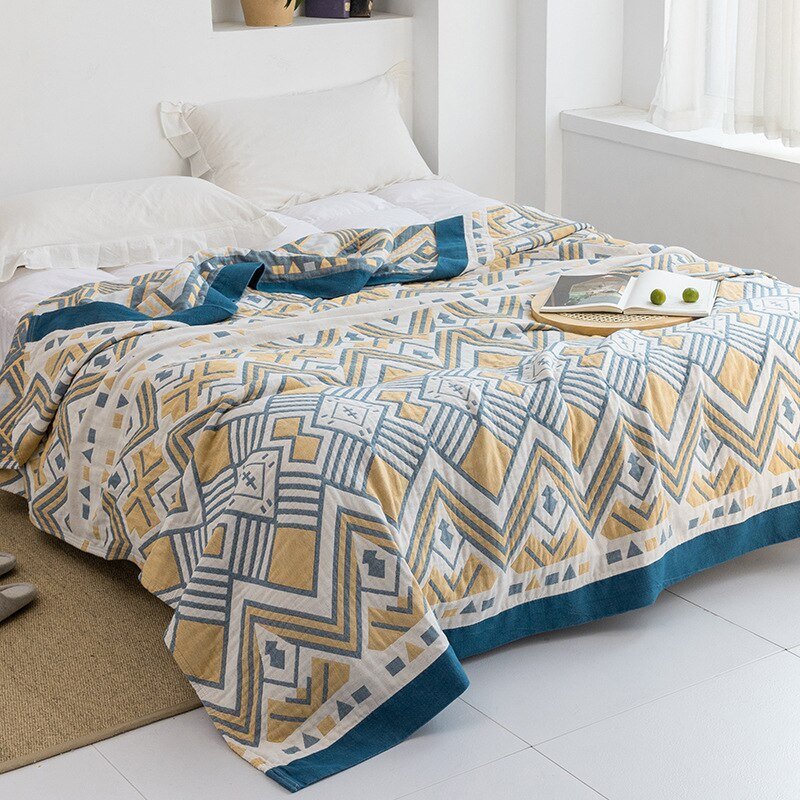 Plaid à motif géométrique, textile doux, parfait comme jeté de canapé moderne et stylé.