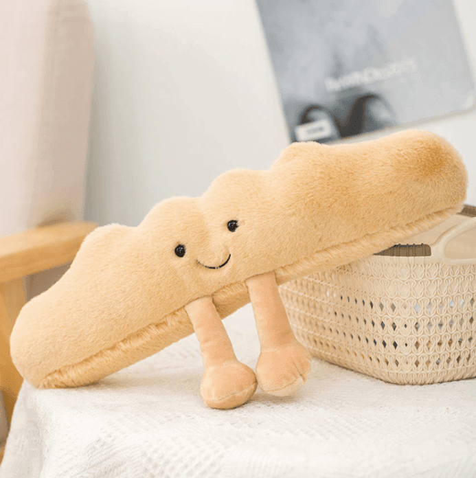 Peluche douce en forme de croissant doré, jouet réconfortant pour enfants et adultes, thème boulangerie.