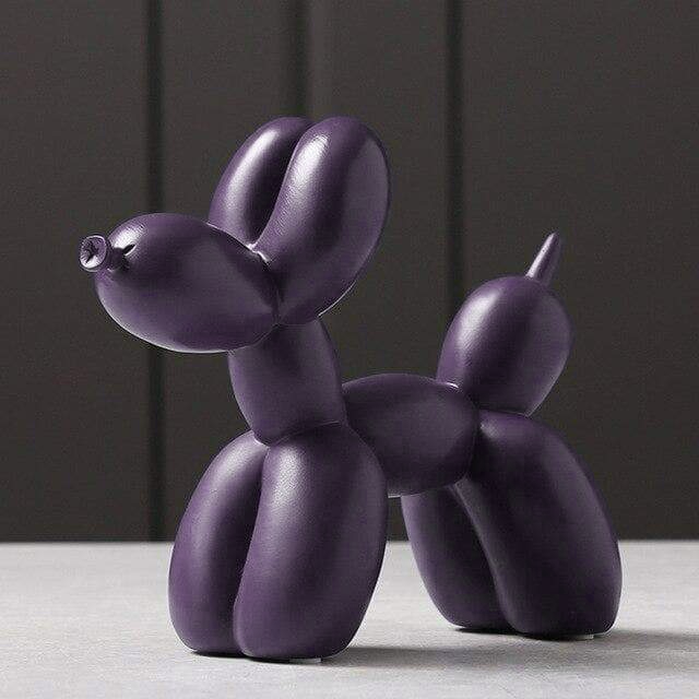 Sculpture chien ballon dorée en résine. Oeuvre d'art luxueuse, parfaite pour une décoration chic de bureau.