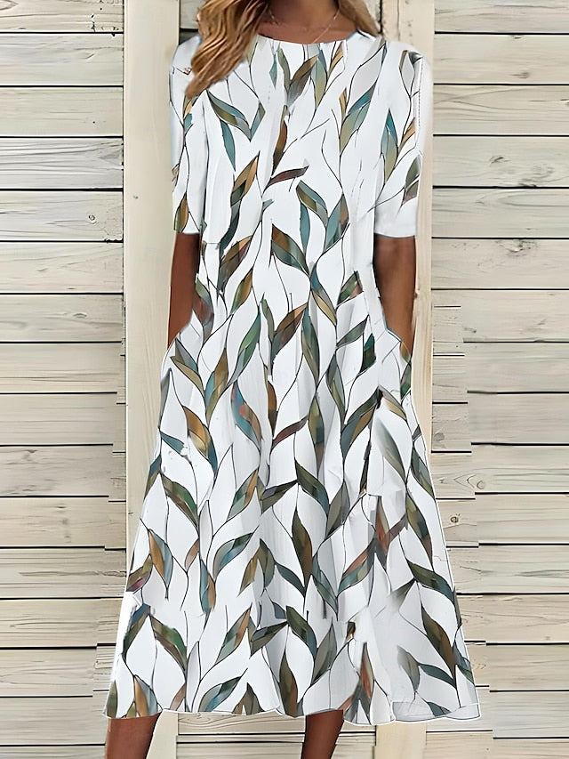 Tenue estivale élégante: robe midi fleurie femme en coton avec manches courtes. Idéale pour un look bohème chic.