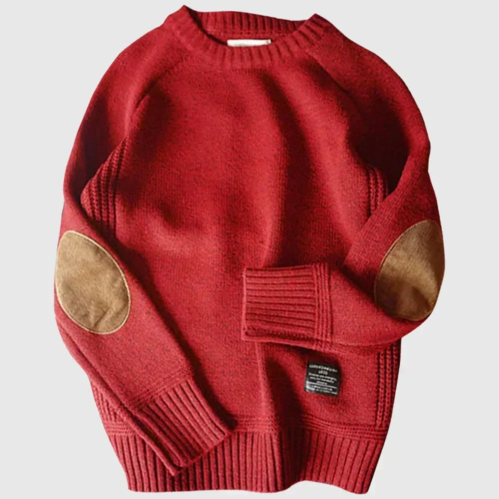 Pull classique homme gris en laine, avec élégants patches aux coudes pour un style intemporel et chaud en hiver.