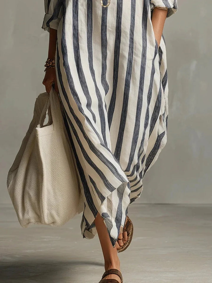 Élégante robe midi femme à rayures printanières, coupe longue ample, dotée de poches, style chic et confortable.