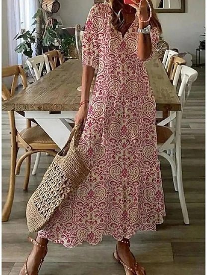 Robe longue décontractée femme avec col en V, motifs géométriques colorés, manches évasées.