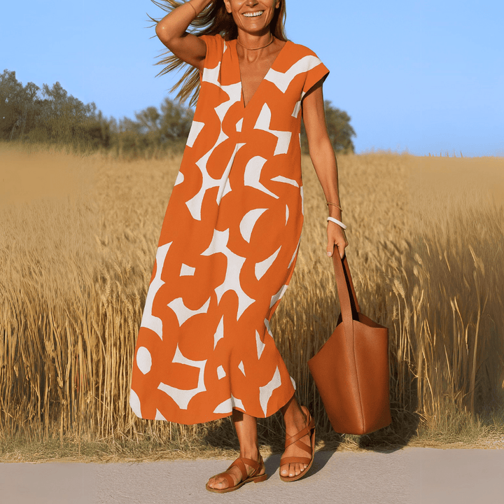 Robe fluide maxi style bohème pour femme avec col V et motifs géométriques, parfaite pour l'été et le confort.