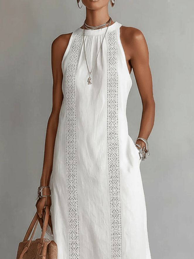 Une femme porte une robe midi fluide élégante, col mandarin, sans manches, pour un look confortable d'été.