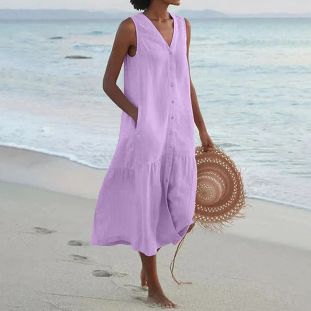 Robe midi femme boutonnée, fluide, sans manches, avec poches, pour un look estival élégant et confortable.