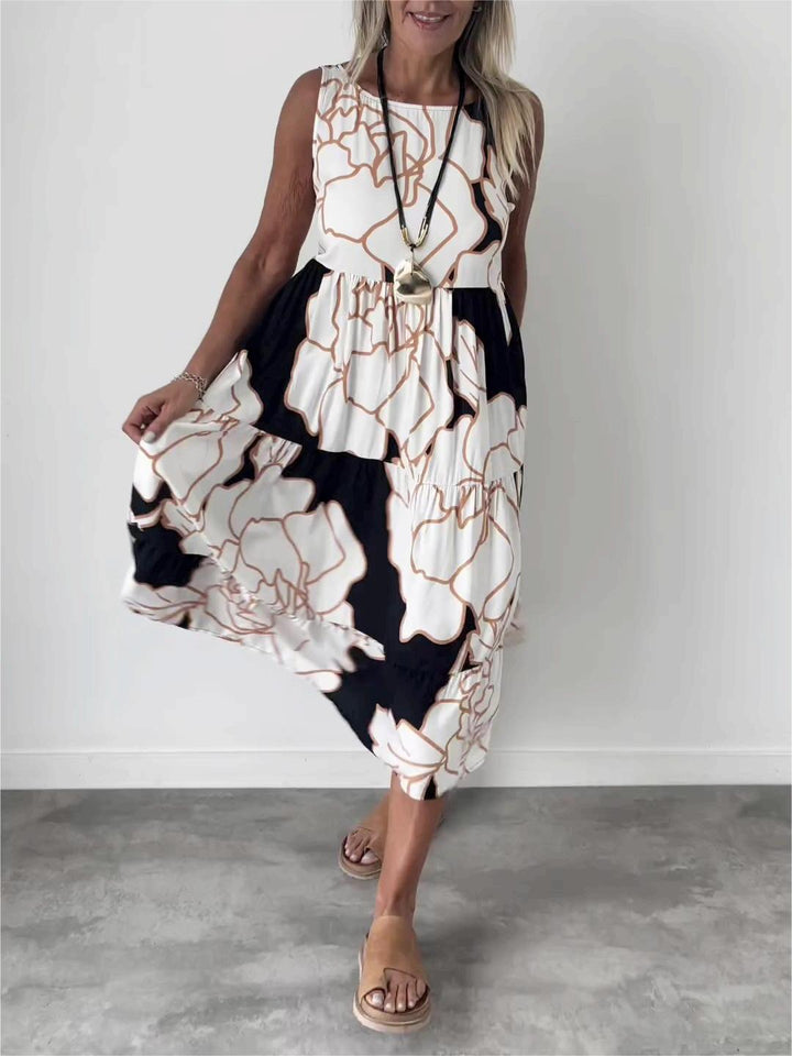 Robe trapèze fleurie fluide pour femme, longueur midi. Imprimé floral, sans manches, parfaite pour une élégance estivale.