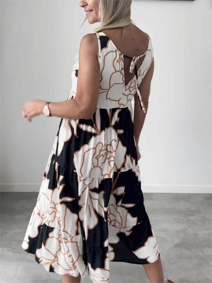 Élégante robe femme midi trapèze ajustable, motif floral chic. Sans manches, parfaite pour une tenue fluide et confortable.