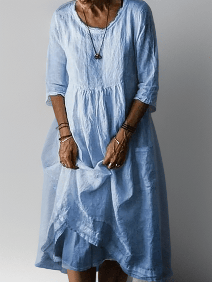 Robe femme midi trapèze confortable, manches 3/4. Parfaite pour une tenue décontractée et élégante.