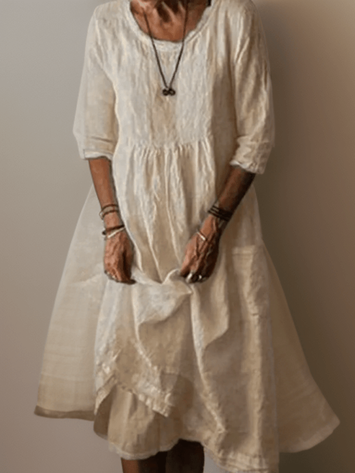 Robe trapèze midi femme à manches 3/4, coupe fluide. Confort et élégance pour un look de jour.