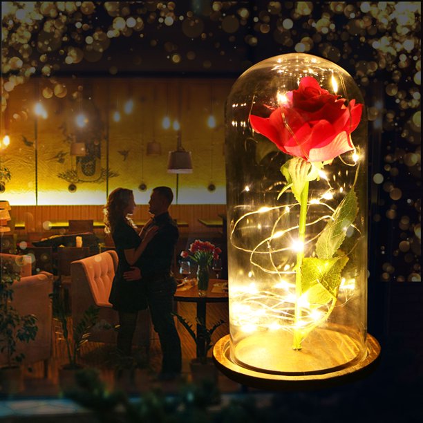Fleur stabilisée rose lumineuse dans cloche en verre, parfaite pour une décoration d'intérieur et une lumière d'ambiance.