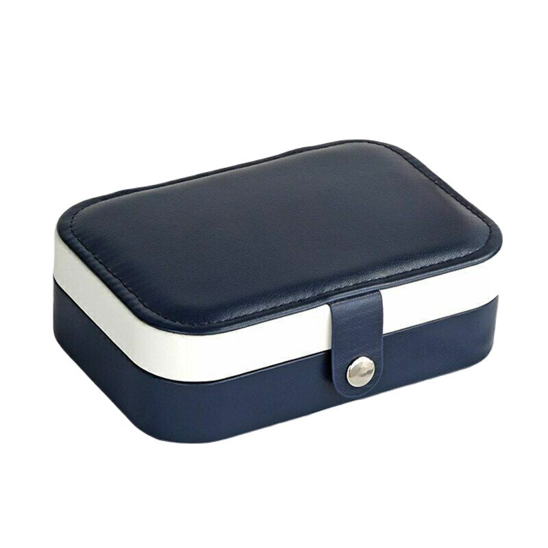 Organisateur de bijoux de voyage en cuir, pratique et compact, avec double compartiment intérieur.