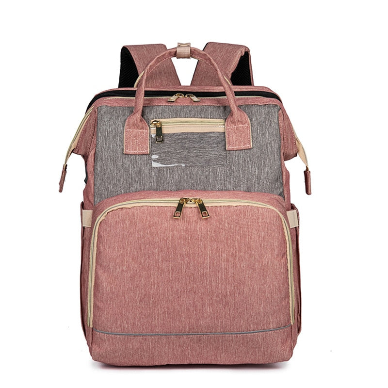 Sac à dos à langer avec lit bébé pliable, pratique pour les parents, offre confort pour sieste nomade et rangement.