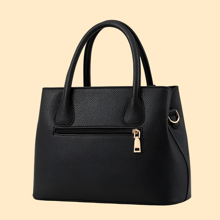 Sac à main femme structuré, porté main, avec pompon élégant. Idéal pour soirée ou quotidien chic.