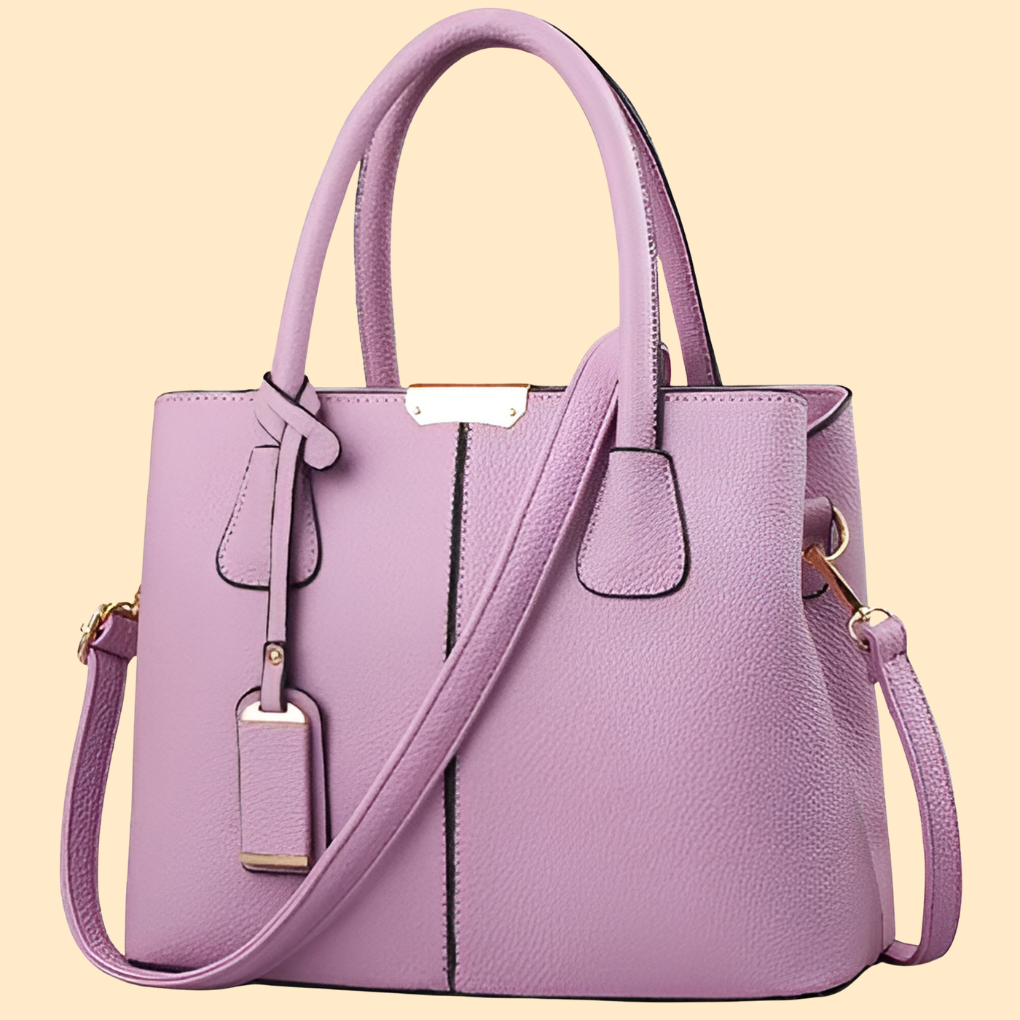 Sac porté main femme chic avec pompon décoratif. Accessoire structuré pour mode élégante et raffinée.