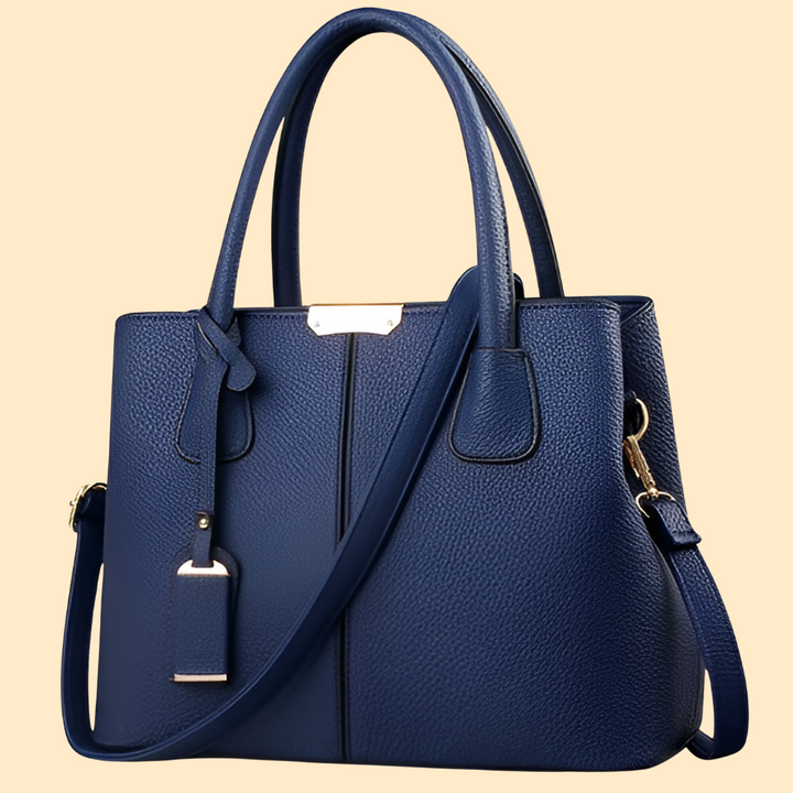 Sac à main femme structuré et chic avec pompon. Accessoire mode élégant, parfait pour compléter votre style.