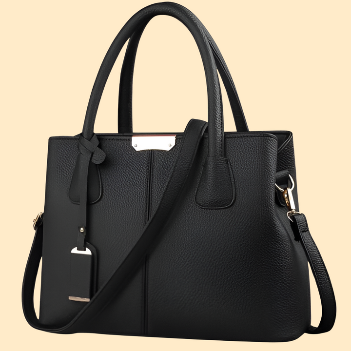 Cadeau femme chic: Sac à main structuré et élégant avec pompon. Accessoire mode intemporel.