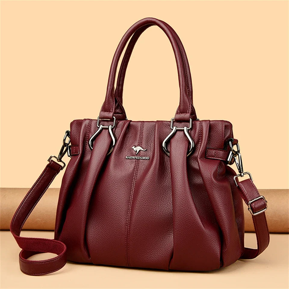 Sac à main femme élégant en cuir bordeaux. Idéal pour le quotidien, accessoire de mode chic avec bandoulière réglable.
