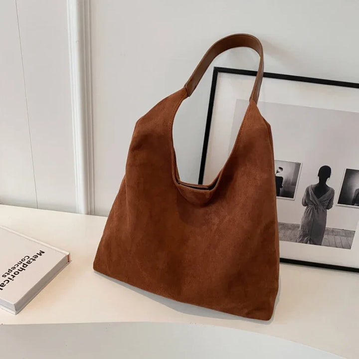 Sac besace femme noir en suédine, un accessoire mode automne, chic et facile à assortir.