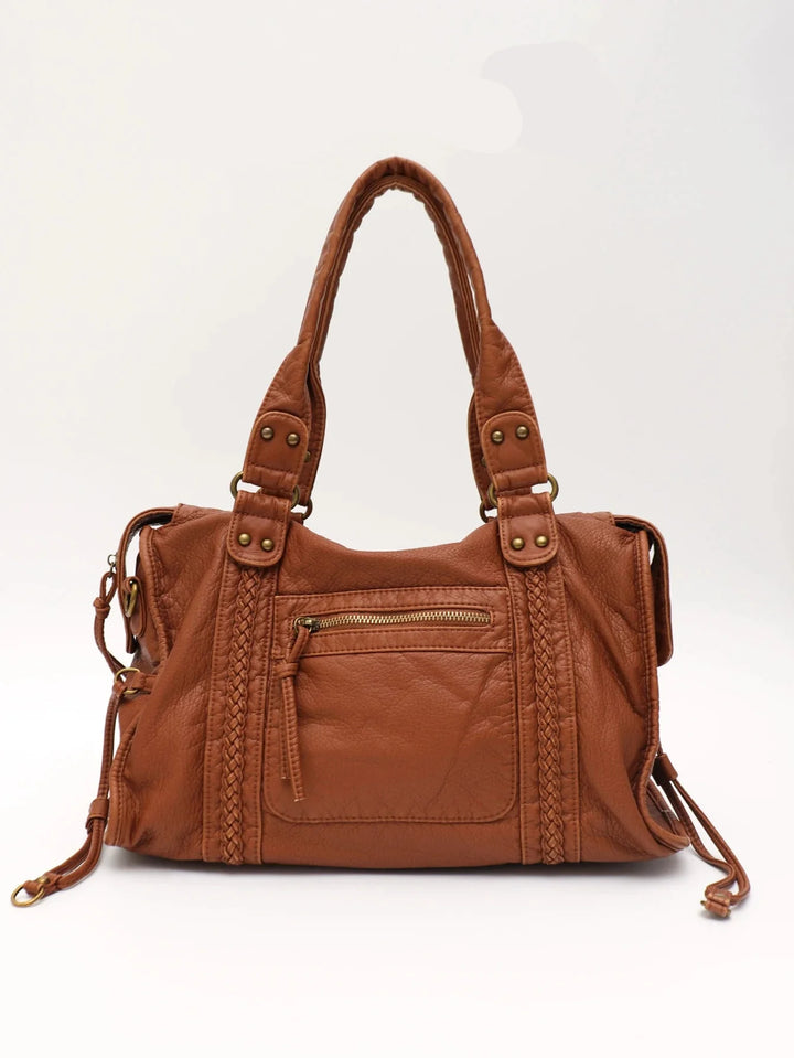 Sac de cours femme élégant, posé sur bureau, style tote bag similicuir, polyvalent pour le lycée.