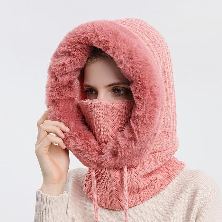 Femme portant un scoodie 3-en-1 élégant, combinant écharpe, bonnet et capuche pour le froid hivernal.