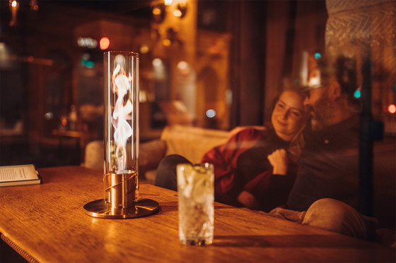 Cheminée de table FlameGlow moderne illuminant un salon, créant une ambiance chaleureuse et sophistiquée.