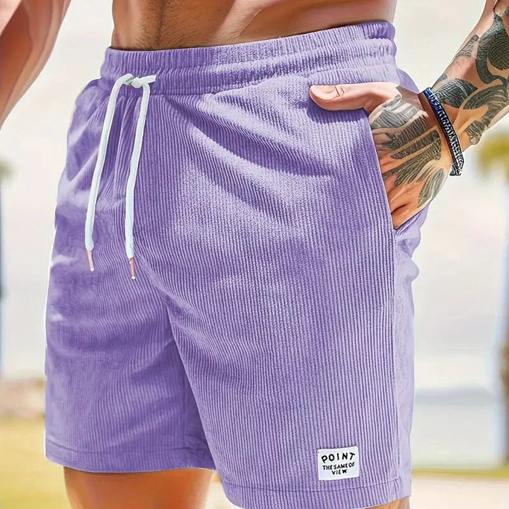 Short homme coupe ample et confortable posé à plat, taille à cordon, mode casual été.