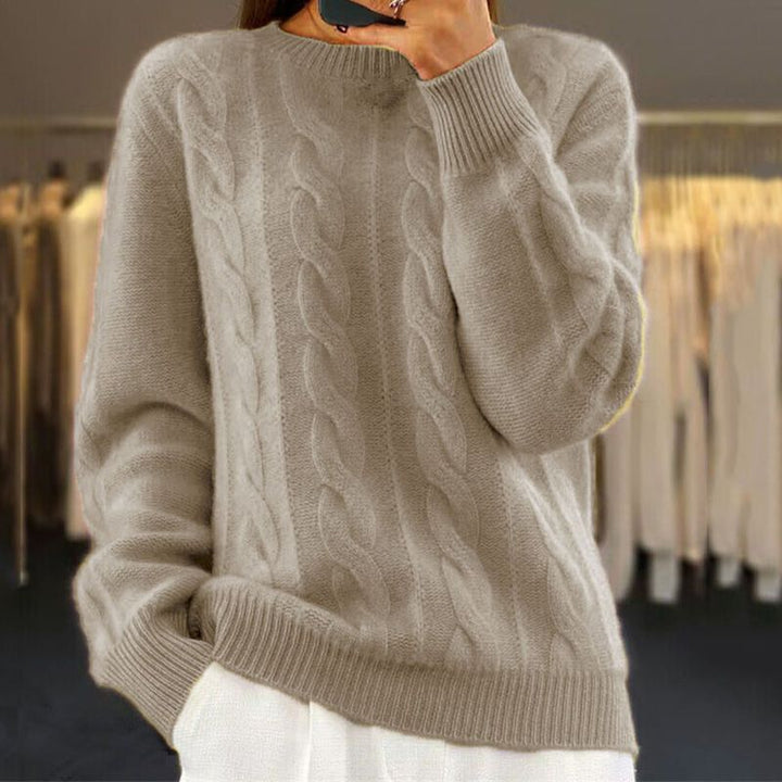 Modèle portant un pull femme torsadé, coupe confortable et style raffiné. Parfait pour la mode automne-hiver.