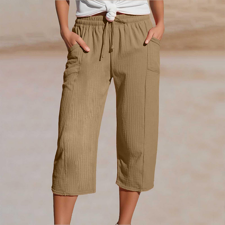 Pantalon femme cropped en coton lin avec taille élastique, offrant confort et souplesse.