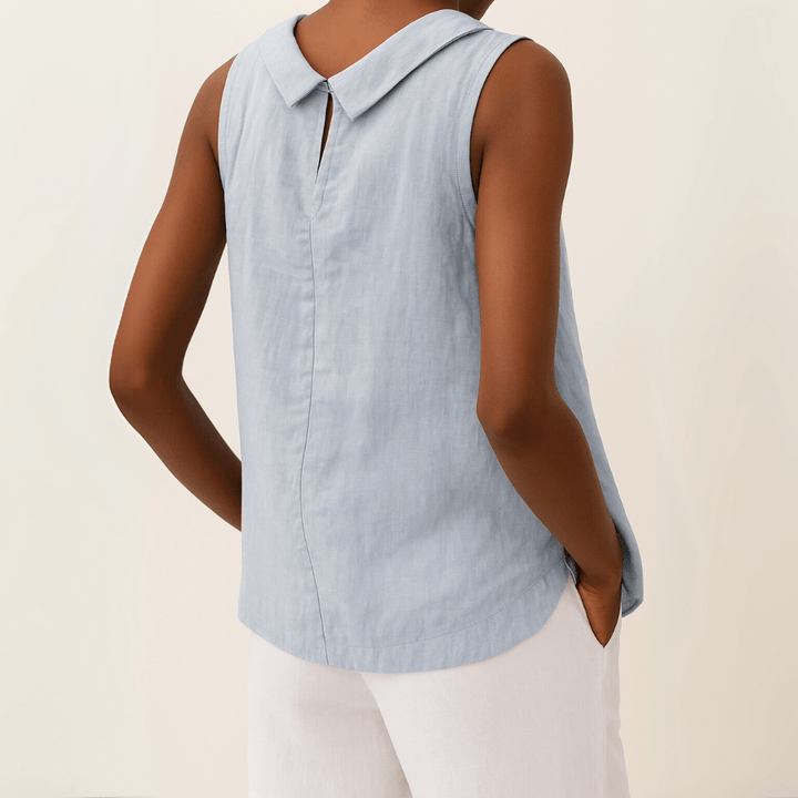 Top femme blanc sans manches, col rond, coupe confortable et décontractée, idéal pour l'été et le quotidien.