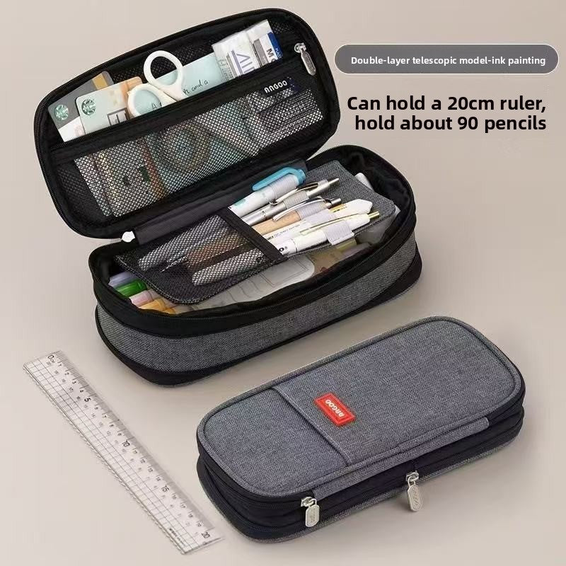 Trousse scolaire double compartiment pour organiser crayons, stylos et fournitures d'école.