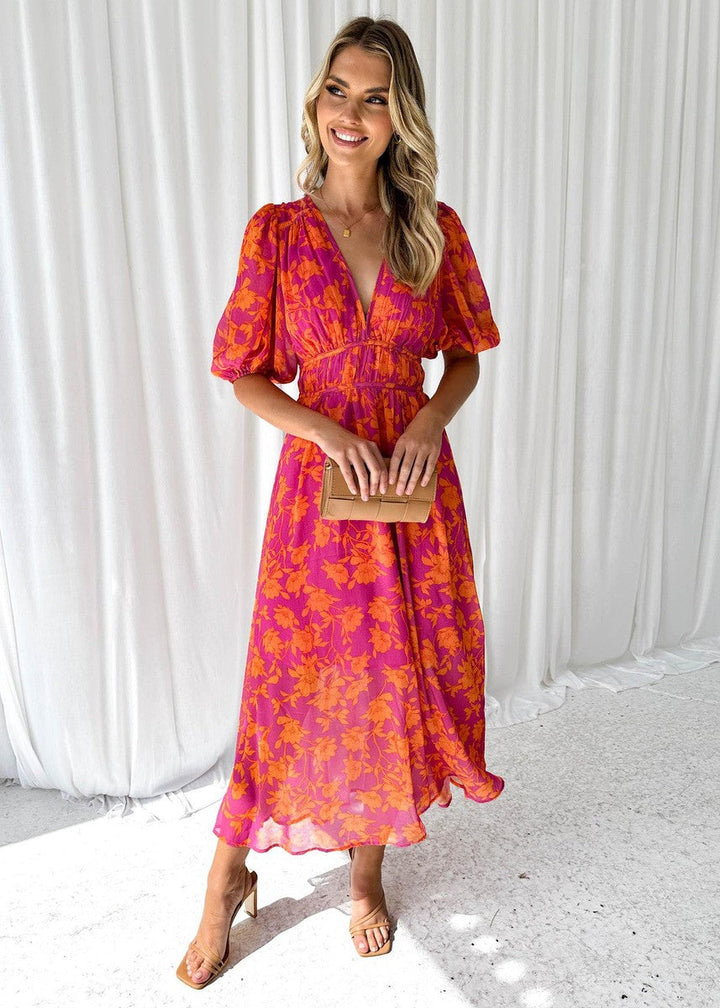 Robe midi fleurie femme avec manches bouffantes et col en V, parfaite pour un style printanier chic et élégant.